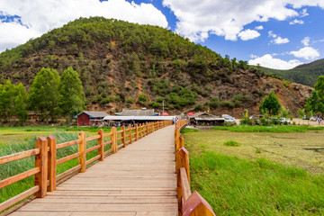 Obraz premium Walking marriages bridge in Lugu Lake, Yunna, China. It is built across CAOHAI, a lake full of water grass on which you can boating or even walk.