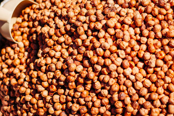 Background from a hazelnut. Close-up texture of heap of hazelnut, overhead view.
