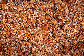 Background from a kernels of walnuts. Close-up texture of heap of unshelled walnuts, overhead view.