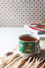Cup of tea and warm knitted blanket. The concept  comfort.