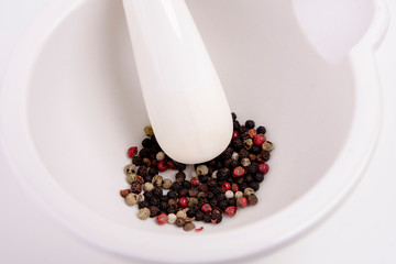 white mortar with coloured peppercorns