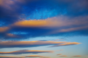 Red-blue clouds in the blue sunset sky.