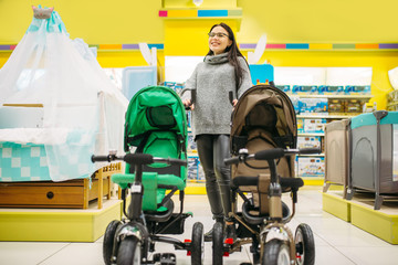 Fototapeta premium Pregnant woman in childrens goods store