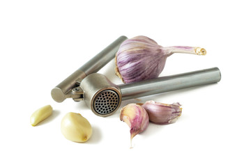 Garlic head, garlic cloves and metal garlic press isolated on white background