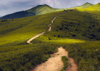 A trail leading up the mountain between two peaks