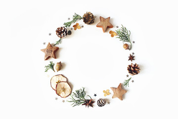 Christmas circle floral composition. Wreath of cypress branches, pine cones, anise, confetti stars,...
