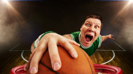 Fototapeta premium Basketball player throws ball, view from basket
