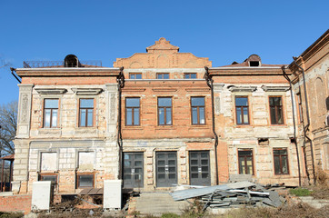 Renovated facade of an old house with a bay window front view.