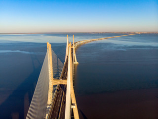 Vasco da Gama Bridge landscape at sunrise. One of the longest bridges in the world. Lisbon is an amazing tourist destination because its light, its monuments. Portugal landmark.