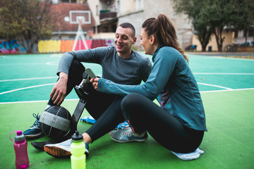 Fototapeta premium Young man with prosthetic leg enjoying with his friend at basketball court.