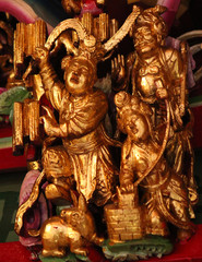 Wooden statues and sculptures showing a historic scene in a buddhist temple in Taichung, Taiwan