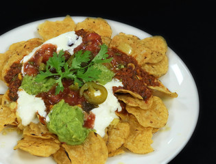 mexican nachos chips with traditional condiments