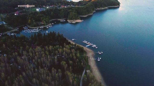 Aerial landscape with Solina Lake in Bieszczady mountains in golden morning light. 3840x2160, 30fps.