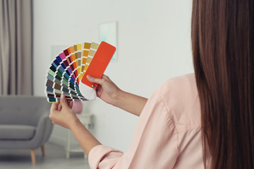 Female interior designer with color palette samples indoors
