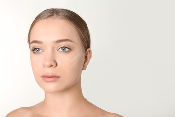 Fototapeta premium Portrait of beautiful young woman with makeup smears on face against white background