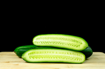 Fresh organic cucumbers on wood