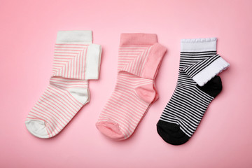Cute child socks on color background, flat lay
