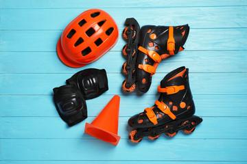 Flat lay composition with inline roller skates on wooden background