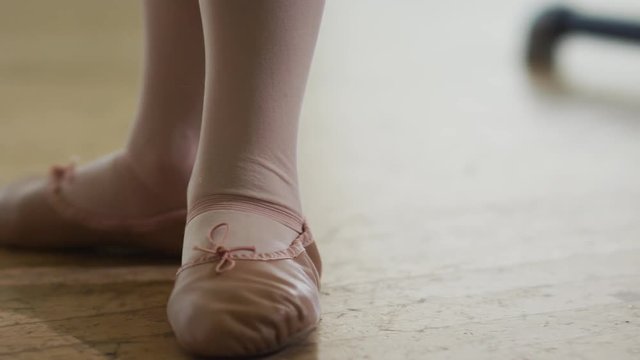 Young girl dancing taking dancing lessons getting approval from her mom day time ballet studio 