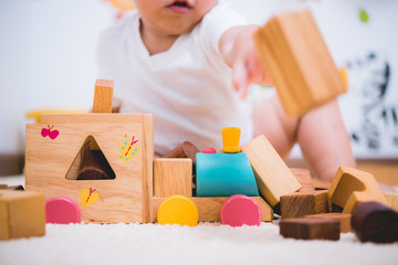 Asian child building playing toy blocks wood