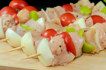 Chicken Shish Kebab with tomato, onion and green peppers on wood
