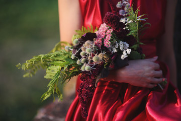 Fototapeta premium A bouquet of fern, of amaranth, thistles, stonecrop