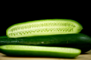 Fresh organic cucumbers on wood
