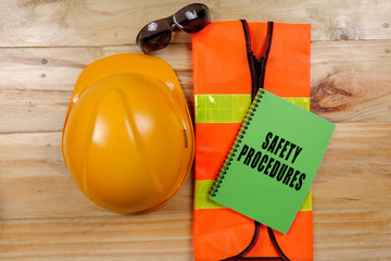 HEALTH,SAFETY & ENVIRONMENT CONCEPTUAL with general texts and standard construction safety equipment.