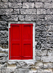 Red Window Shutters on a Stone Wall in Nassau, Bahamas