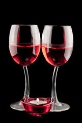 two glasses of red wine with candle 