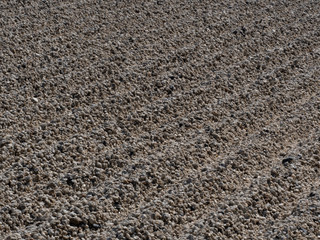 pebbles surface with wave pattern, style of japanese gardening their garden