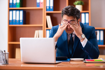 Young handsome businessman working in the office