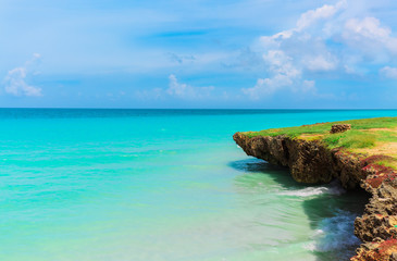 Fototapeta na wymiar natural amazing beautiful landscape view on tranquil turquoise ocean and cliff with blue cloudy sky background in Varadero, Cuban beach