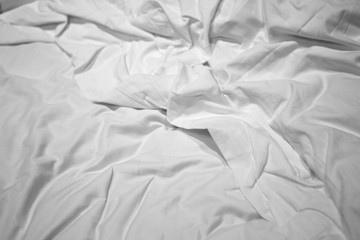 Empty crumpled bed in the bedroom after walk up.