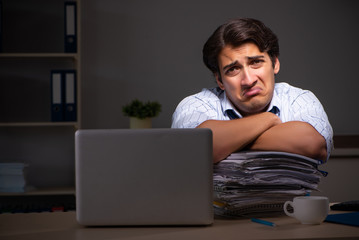 Young financial manager working late at night in office 