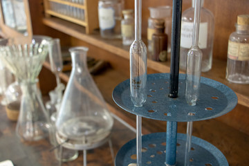 Old Science equipment for chemical experiment and produce. Vintage glass bottles on wooden table,...