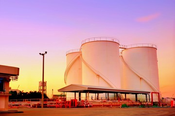 Industrial view of oil storage tanks in refinery plant of chemical industry area with colorful...