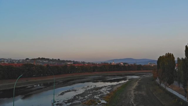 View from the height of the city on the roofs of houses, trees, mountains in over the Uzh River