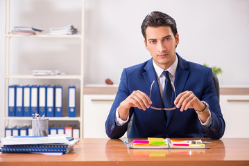 Young handsome employee planning his work activity 