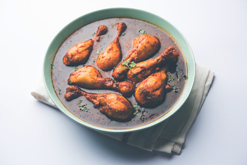Chicken leg / drumstick curry or Murg Tangri/tangdi masala. Served in a bowl over moody background. Selective focus