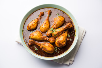 Chicken leg / drumstick curry or Murg Tangri/tangdi masala. Served in a bowl over moody background. Selective focus