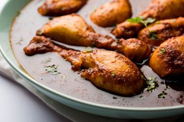 Chicken leg / drumstick curry or Murg Tangri/tangdi masala. Served in a bowl over moody background. Selective focus