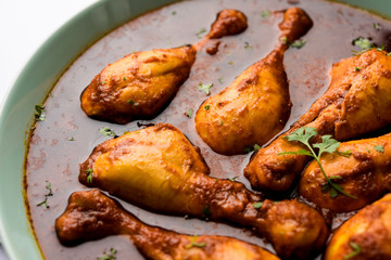 Chicken leg / drumstick curry or Murg Tangri/tangdi masala. Served in a bowl over moody background. Selective focus