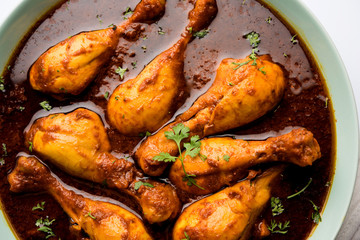 Chicken leg / drumstick curry or Murg Tangri/tangdi masala. Served in a bowl over moody background....