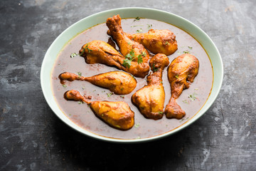 Chicken leg / drumstick curry or Murg Tangri/tangdi masala. Served in a bowl over moody background. Selective focus