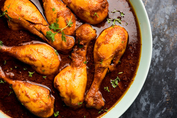 Chicken leg / drumstick curry or Murg Tangri/tangdi masala. Served in a bowl over moody background. Selective focus