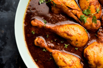 Chicken leg / drumstick curry or Murg Tangri/tangdi masala. Served in a bowl over moody background. Selective focus