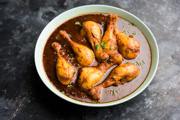 Chicken leg / drumstick curry or Murg Tangri/tangdi masala. Served in a bowl over moody background. Selective focus