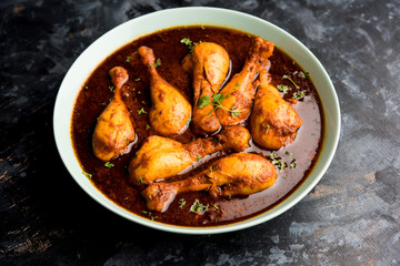 Chicken leg / drumstick curry or Murg Tangri/tangdi masala. Served in a bowl over moody background. Selective focus