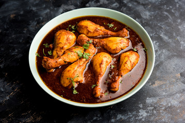 Chicken leg / drumstick curry or Murg Tangri/tangdi masala. Served in a bowl over moody background. Selective focus